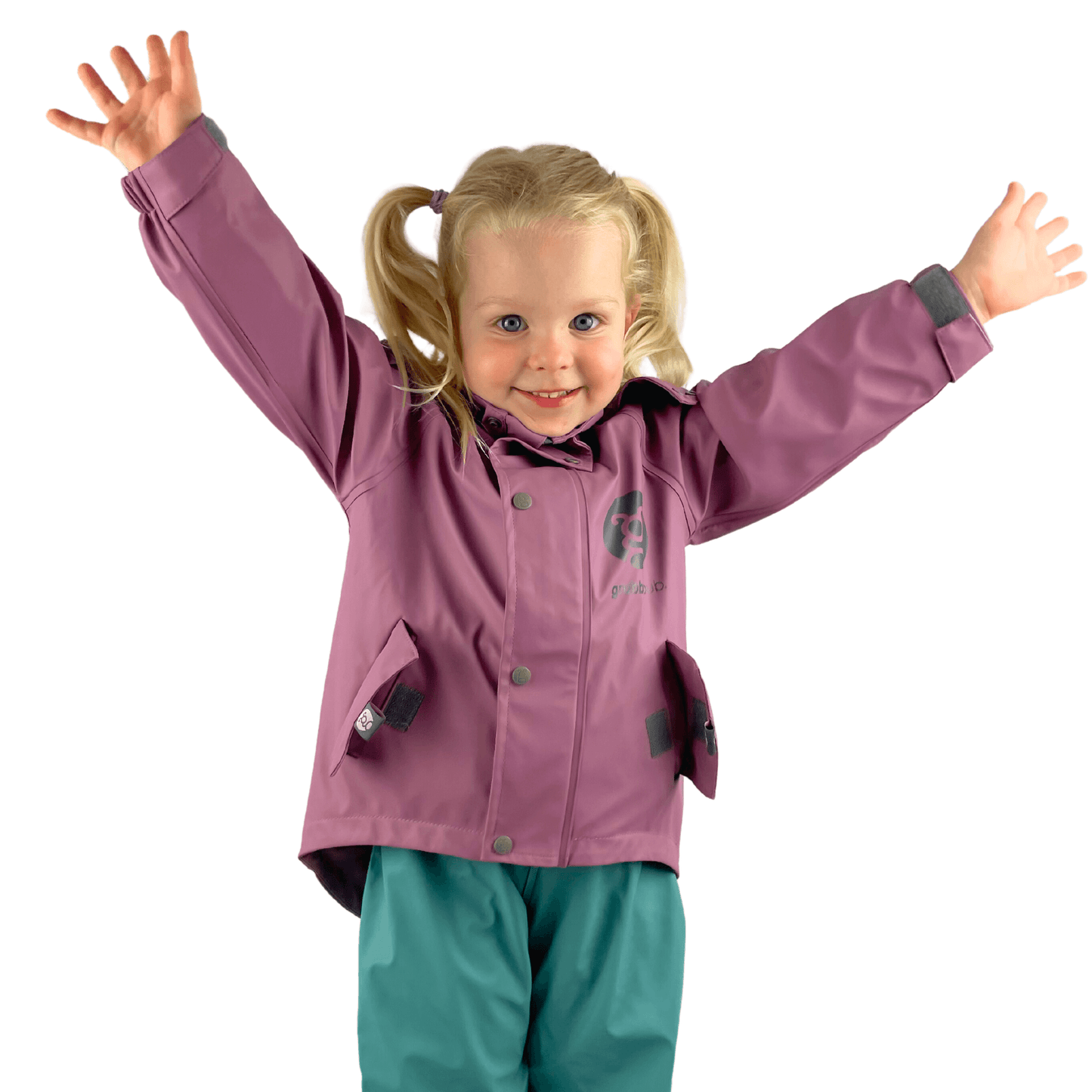 Young toddler in a plum purple waterproof raincoat on a white background