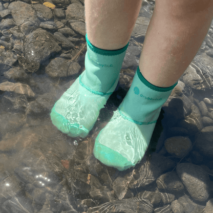 Toddler water shoes and pre walker wellies, soft sole barefoot boots for creek and outdoor play. Child in wee wellies walking in creek